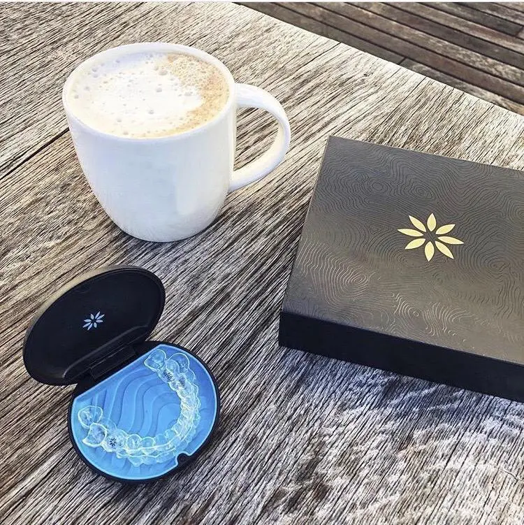 Invisalign na caixinha com uma xicara de café do lado